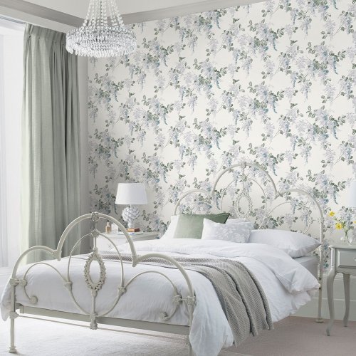 Laura Ashley Mirabelle Pale Seaspray Wallpaper styled in a bedroom, creating a soft and elegant botanical atmosphere