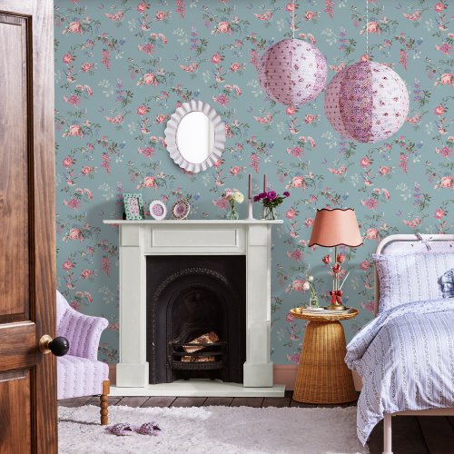 Room decorated with Birds and Roses Summer wallpaper, showcasing vibrant pastel florals and birds against a soft blue backdrop.