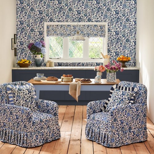 Room decorated with Strawberry Garden Blue wallpaper, featuring a contemporary fruit and floral design on a cream backdrop.