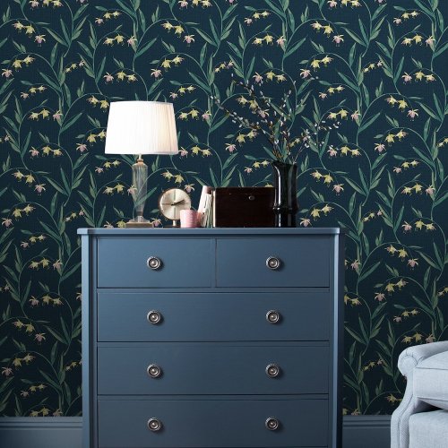 Midnight seaspray floral wallpaper with pink and yellow fuchsia flowers and arched green leaves.