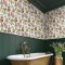 Physic Garden Lush Wallpaper featuring exotic botanical florals and fruits on a soft background