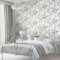 Laura Ashley Mirabelle Pale Seaspray Wallpaper styled in a bedroom, creating a soft and elegant botanical atmosphere