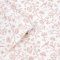 A roll of Laura Ashley Shepherd's Purse Dark Blush Wallpaper showcasing its intricate botanical print in blush pink on ivory