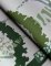 Roll shot of Unify Green Wallpaper with artistic tree patterns and organic detailing