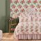 Room decorated with Archive Rose Pink Blooms wallpaper, featuring classic red and pink roses against a cream backdrop.