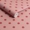 Roll of Button Spot Pink wallpaper showcasing classic polka dot design