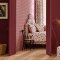 Room decorated with Button Spot Pink wallpaper, featuring playful cream polka dots on a pink backdrop