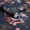 Roll of Painted Kingdom Navy wallpaper showcasing whimsical animals and vibrant florals