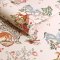 Roll of Painted Kingdom Pink wallpaper showcasing pastel spheres with playful animals and florals